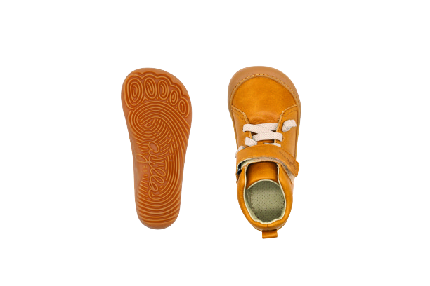 Top and bottom of kid's barefoot shoe sand color.