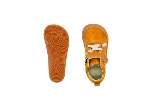 Top and bottom of kid's barefoot shoe sand color.
