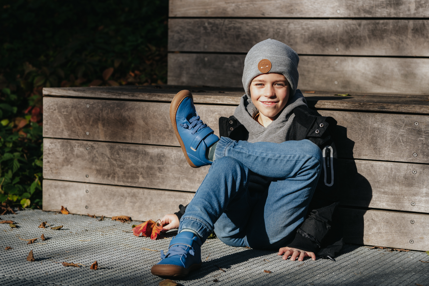Kid wearing blue barefoot shoes.
