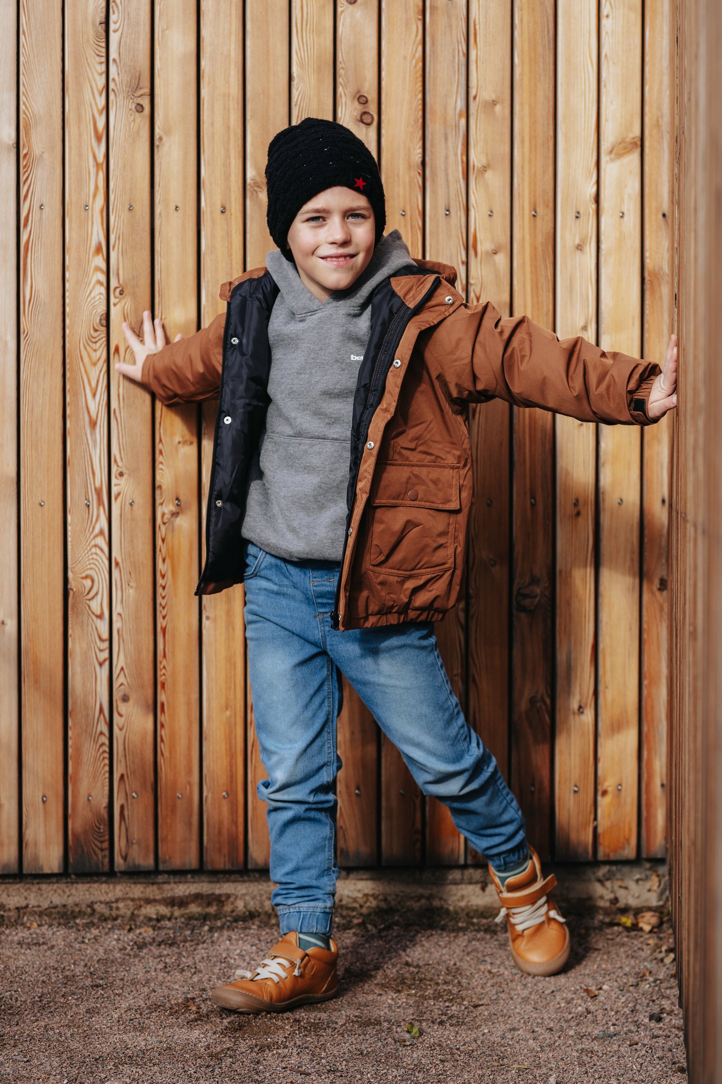 Boy waring sand color barefoot shoes.