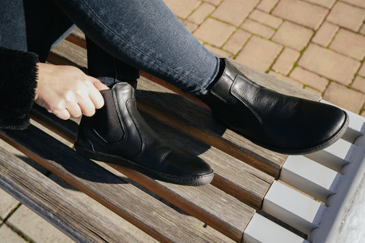 Detailed realistic photo of black Chalsea style barefoot shoe